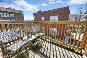 a balcony with a table and chairs on a deck at 3 King Beds/3Baths Spacious in Soulard