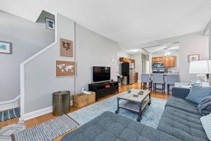 a living room with a couch and a table at 3 King Beds/3Baths Spacious in Soulard