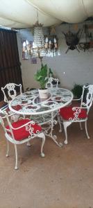 a table and two chairs with a potted plant on it at La Ruta del Jazz in Santa Cruz