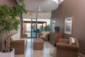 a living room with wicker chairs and a tv at Lykia World Links Golf Antalya in Denizyaka