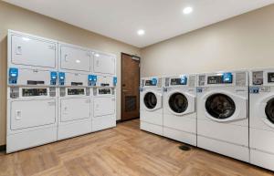 a row of white washing machines in a laundry room at Extended Stay America Premier Suites - Pueblo in Pueblo