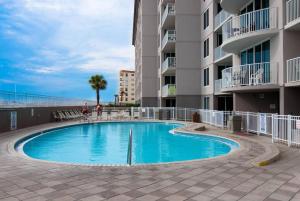 a swimming pool in front of a apartment building at Island Princess 707 Grouper Therapy in Fort Walton Beach
