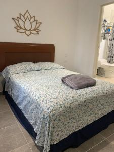 a bed with a pillow sitting on top of it at CASA JARDIN in Cancún