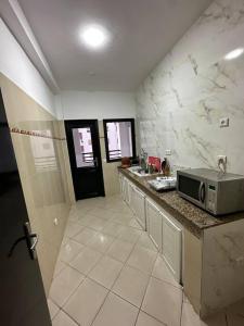 a kitchen with a sink and a microwave on a counter at Appartement de lux à agadir in Agadir