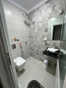 a bathroom with a toilet and a sink at Appartement de lux à agadir in Agadir