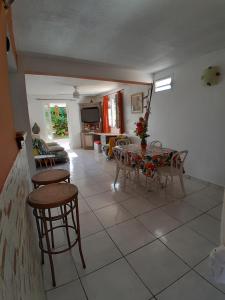 a living room with a table and chairs at KAY MIT et KAY JACKO in Sainte-Luce