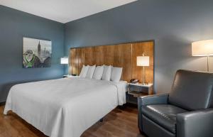 a hotel room with a bed and a chair at Extended Stay America Premier Suites - Pueblo in Pueblo +35 photos