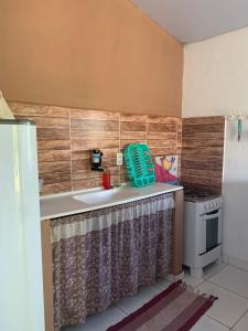 a kitchen with a sink and a stove at Sítio Vila das Flores in Tibau do Sul