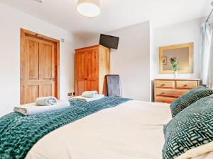 a bedroom with a large bed and a dresser at 1 Bed in Sennen GIDUP in St Just
