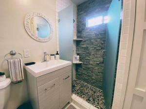 a bathroom with a sink and a shower with a mirror at 2min2Beach, Netflix, A/C, W/D,15min2LAX, Fast Wifi in Hermosa Beach
