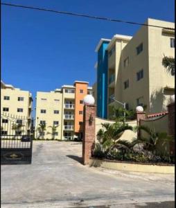 a parking lot in front of some buildings at Beautiful condo in La Romana near Caleta beach in La Romana