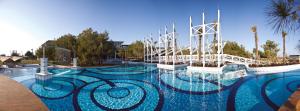 a large swimming pool with blue water at Lykia World Links Golf Antalya in Denizyaka