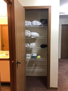 a closet with a door open with towels at 2 bedroom apartment RivianISU in Bloomington