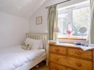 a bedroom with a bed and a dresser and a window at 2 Bed in Cerne Abbas BRAMC in Cerne Abbas
