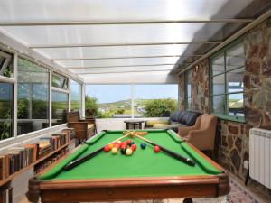 a pool table in a living room with a pool table at 3 Bed in Widemouth Bay 77815 in Marhamchurch