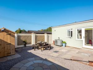 a backyard with a picnic table and a fence at 3 Bed in Wroxham 79211 in Dilham