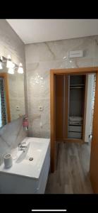 a bathroom with a white sink and a mirror at A Fonte in Estarreja