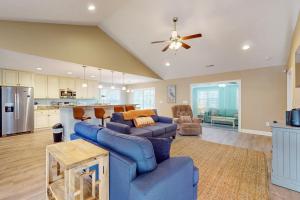 a living room with a blue couch and a ceiling fan at Marina's Edge in Myrtle Beach