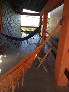 a room with a hammock in a building at Casa de Porto de Galinhas 137 in Porto De Galinhas