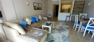 A Residence - Superior One Bedroom Aparthotel في شرم الشيخ: غرفة معيشة مع أريكة وطاولة