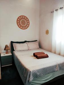 a bedroom with a bed with a towel on it at Casa confortável, pertinho da cidade e conectada a natureza in Brasília