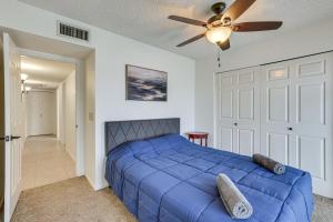 a bedroom with a blue bed and a ceiling fan at 8 Mi to State Farm Stadium Home with Pool in Peoria +26 photos