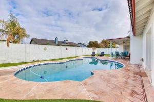 a swimming pool in the backyard of a house at 8 Mi to State Farm Stadium Home with Pool in Peoria