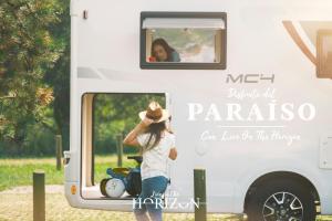 a woman looking out the window of a white trailer at Live On The Horizon 1 in Ribadesella