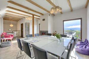 a dining room with a large white table and chairs at Willa Widokówka Lubawka in Lubawka