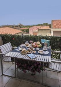 a table with food on it on a balcony at Residenza Piccolo Eden in Bosa Marina