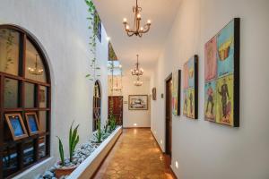a hallway of a home with paintings on the walls at Guaycura Boutique Hotel, Beach Club & Spa in Todos Santos