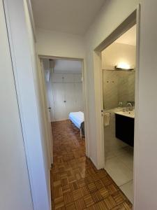 a room with a bathroom with a sink and a bed at Dpto Olleros in Buenos Aires