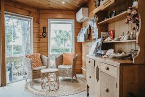 a living room with two chairs and a table at Tatahi Lodge Beach Resort in Hahei