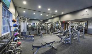 a gym with several treadmills and machines in it at Cozy Home Management in MDR in Los Angeles