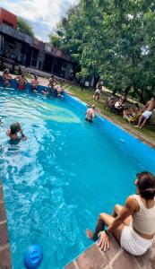 a group of people playing in a swimming pool at BROTHERS HOSTEL in Villa Allende