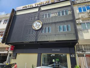 a building with a clock on the front of it at Alia Express Hotel Twelve a12 Kuantan in Kuantan