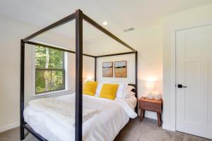 a bedroom with a large canopy bed with yellow pillows at The Linden, large & luxurious Galena escape! in Galena