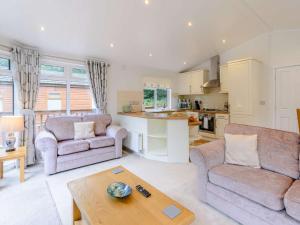 a living room with a couch and a table at 2 Bed in Okehampton 85432 in Okehampton