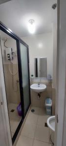 a bathroom with a shower and a sink and a toilet at 1608 Three Bedrooms With 1 free parking, swimming pool WiFi and Netflix at Northpoint Camella Condominium Bajada Davao City in Davao City