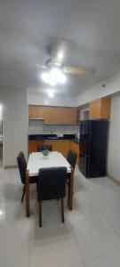 a kitchen with a table and chairs in a room at 1608 Three Bedrooms With 1 free parking, swimming pool WiFi and Netflix at Northpoint Camella Condominium Bajada Davao City in Davao City