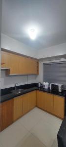 a kitchen with a sink and a counter top at 1608 Three Bedrooms With 1 free parking, swimming pool WiFi and Netflix at Northpoint Camella Condominium Bajada Davao City in Davao City