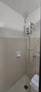 a bathroom with a shower and a toilet at 1608 Three Bedrooms With 1 free parking, swimming pool WiFi and Netflix at Northpoint Camella Condominium Bajada Davao City in Davao City
