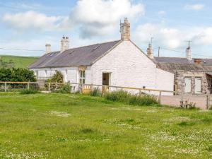 an old white house with a grass field in front at 2 Bed in Mindrum 56401 