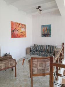 a living room with a couch and a table at Moon Deck Villa in Katunayake