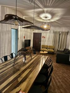 a conference room with a large wooden table and chairs at BROTHERS HOSTEL in Villa Allende