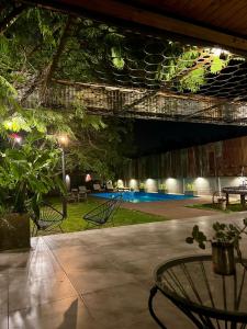 an outdoor patio with tables and chairs at night at BROTHERS HOSTEL in Villa Allende