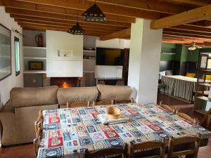 a living room with a table and a couch at Casa Rural Monterrey Aroche in Aroche