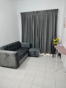 a living room with a couch and a window at CMN Hotel & Homestay in Sungai Petani