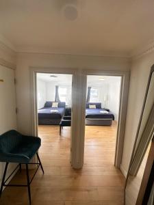 a room with two beds and a chair in it at Flat 1 Stay In Aldgate in London