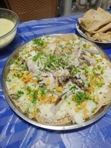 a plate of food on a blue table at Petra Musa Rural House in Wadi Musa